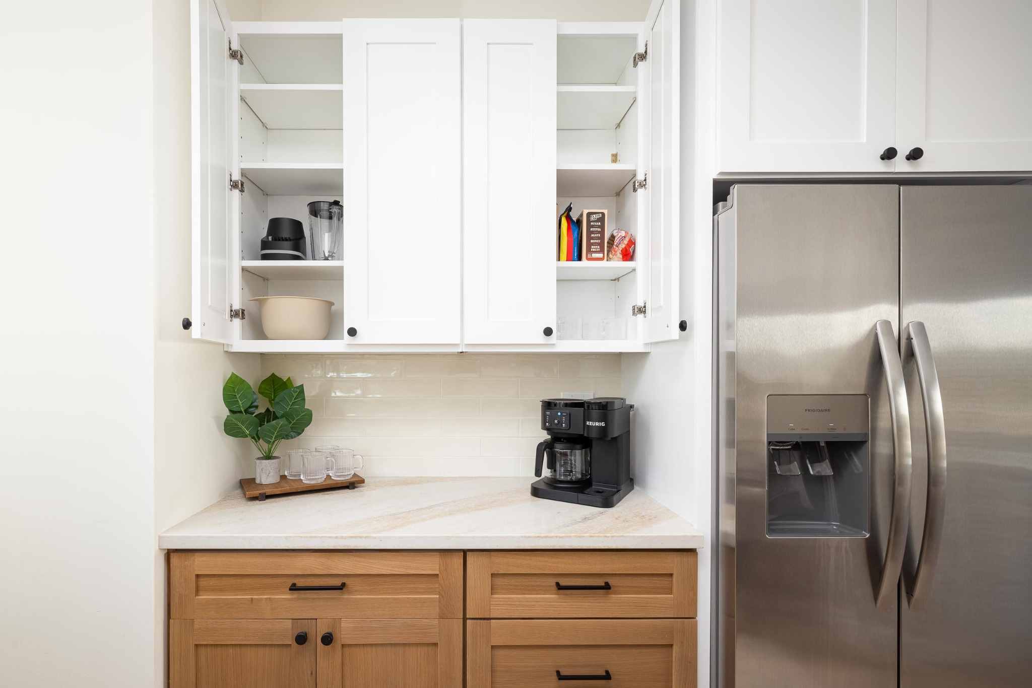 Detailed custom kitchen cabinetry and stainless steel refrigerator